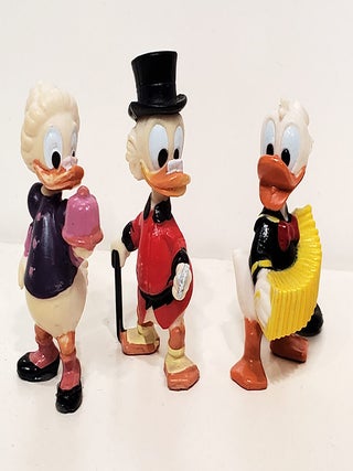 A Group of Nine Vintage Disney Mini Figurines. (Donald Duck, Uncle Scrooge, Daisy Duck, Gyro Gearloose, Grandma Duck, etc.)